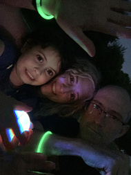 R, T, and I selfie covered in glowsticks as the sun has fully gone down and we are trying to see what is going on without attracting too many moths and other nighttime bugs