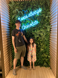 R and I posing in one of the very instagrammable photobooths in the chocolate nation museum in Antwerp.  There is a blue neon sign behind us that says It was always chocolate