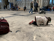 R searching for something on the paving slabs of York Minster with the magnifying glass from her backpack - I think we are in the nave or something?