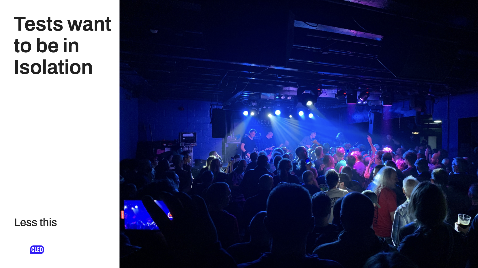 A photo of a band on stage in a small, but packed venue, from the perspective of an audience member; text: Tests want to be in Isolation; Less this