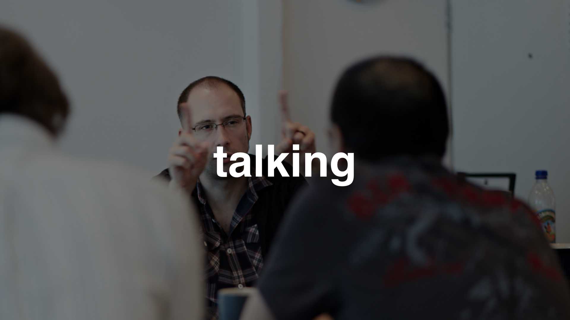 A photo of some people talking - text: talking